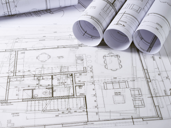 Rolled up architecture plans and sketchings of a house project