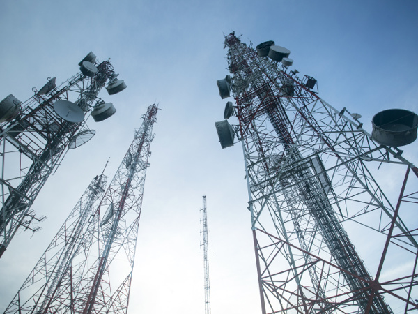 Telecommunication mast TV antennas against blue sky in the morning