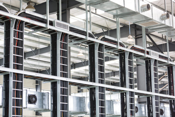 Organized cable trays and air ducts installed in a modern industrial facility