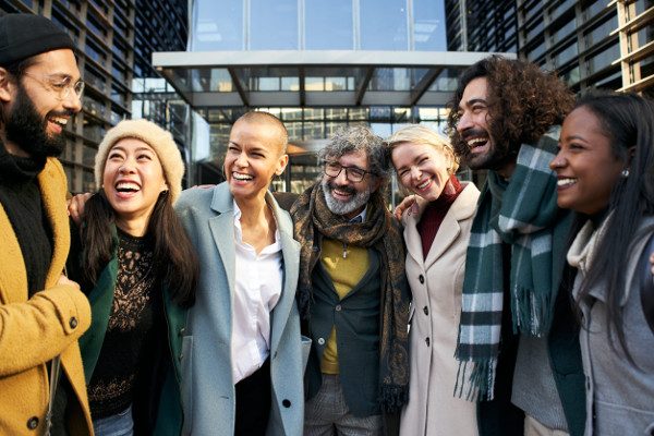Diverse group of friends laughing and having fun together in the city