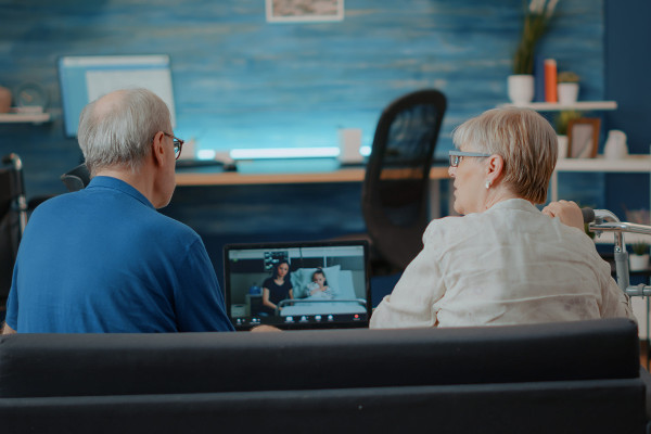 Senior people attending a video call meeting with relatives