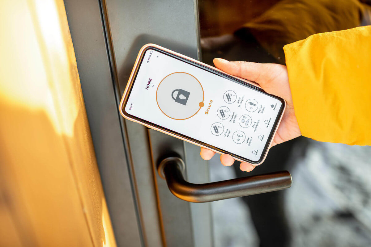 Person locking the smartlock on an entrance door using mobile phone
